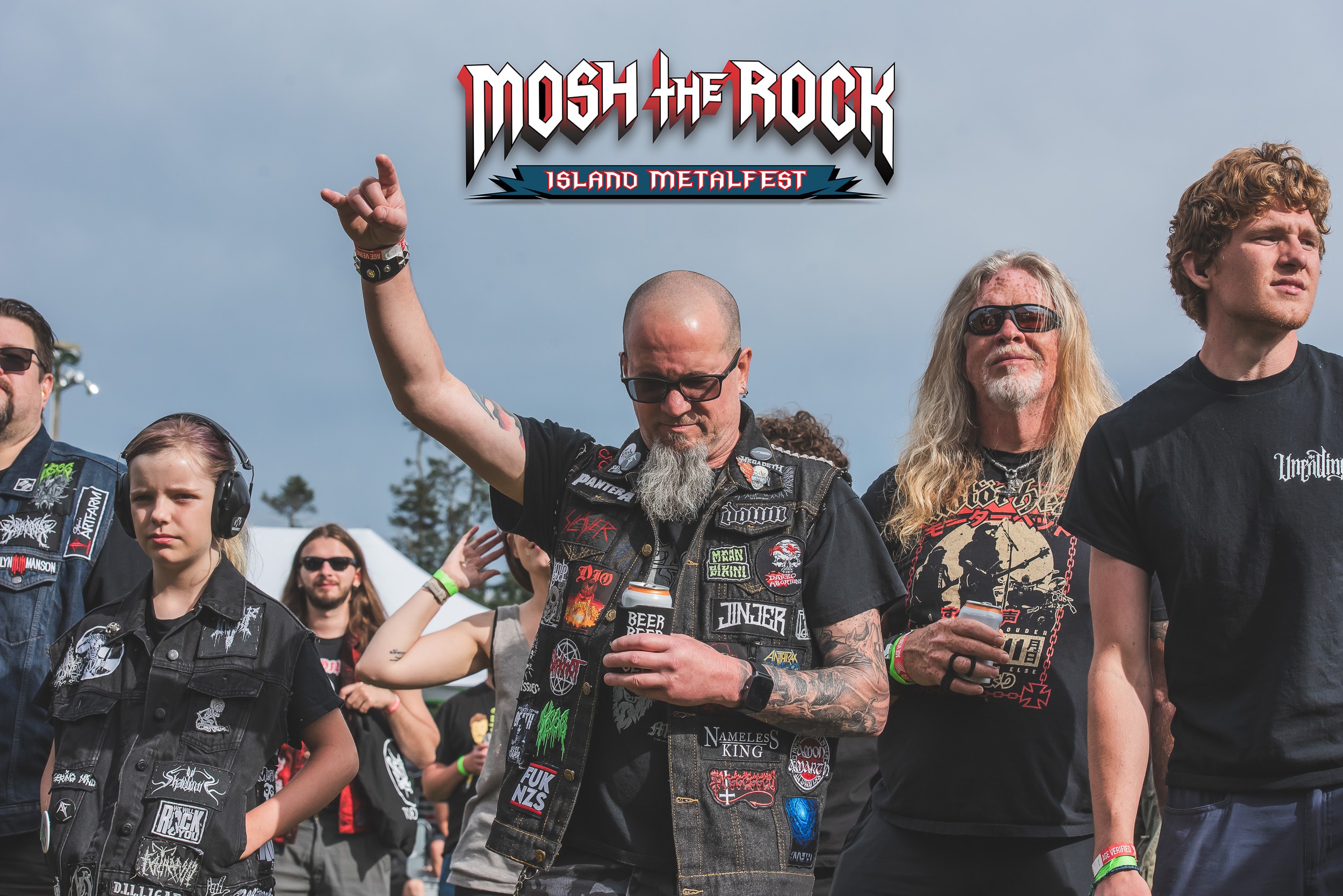 Metal fans throwing the horns in the crowd at Mosh the Rock
