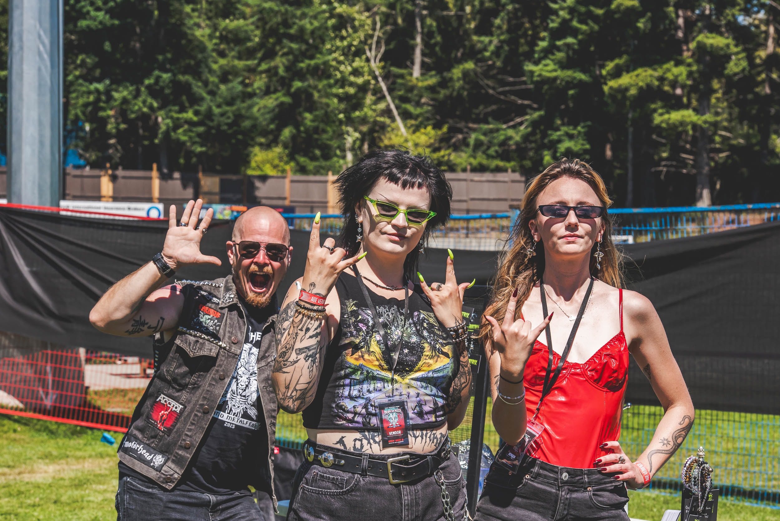 Three fans throwing the horns at Mosh the Rock Island Metalfest